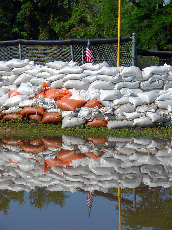 The US flag in a sandbag levee reflected in flood waters (309.73 KB)