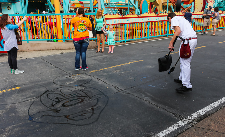 This was cool. This supposed custodian came out with this bucket, broom and water and drew Mickey on the pavement. (284.45 KB)